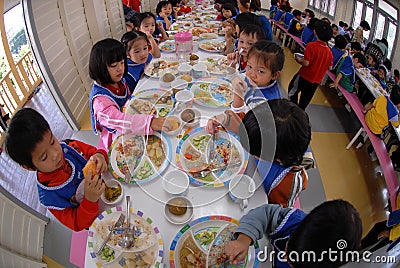 Primary school students eat lunch in the school canteen. Editorial Stock Photo