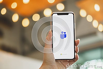 BANGKOK THAILAND - MAY 17, 2020 : Close up image of a user is holding IphoneX and showing the Microsoft Teams Logo on the device Editorial Stock Photo