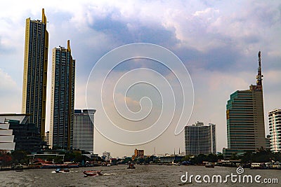 Bangkok, Thailand - May 18, 2019: The landscape skyline at Chao Pra Ya river with boat, pier, tower and skyscrapers Bangkok Thail Stock Photo