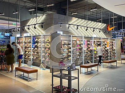 Many running shoes on a shelf in the Nike booth Editorial Stock Photo