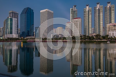 BANGKOK, THAILAND - 7 Nov 2019 :Reflection office building water front a Benjakiti green park Twilight Editorial Stock Photo