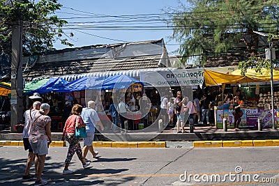 Bangkok, Thailand - November 30, 2019: Shoppers cross the street to enter the famous Chatuchak Weekend Market to visit all of the Editorial Stock Photo