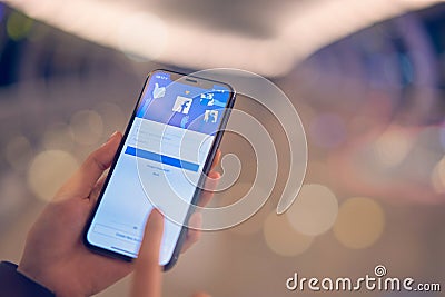 Bangkok, Thailand - October 24, 2019 : hand is pressing the Facebook screen on apple iphone, Social media are using for Editorial Stock Photo