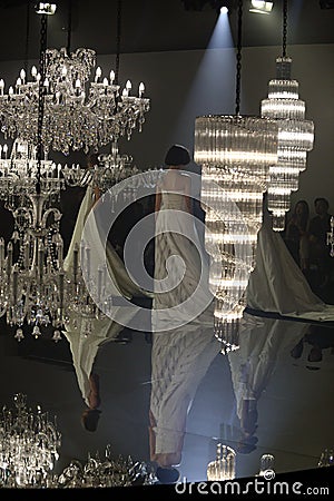 Fashion Show of Wedding dress and Evening Gown along Chandelier Editorial Stock Photo