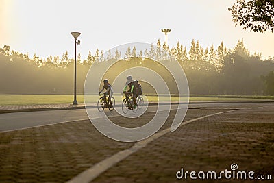 Bangkok Thailand - 15 Sep 2019 : Three men riding on bicycle in Suan Luang Rama IX public park in morning. Editorial Stock Photo