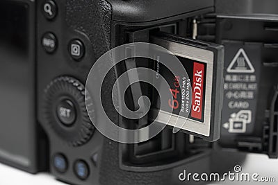 View of the New Canon EOS R5 Mirrorless Camera with the new Sanddisk CF Express Card Editorial Stock Photo