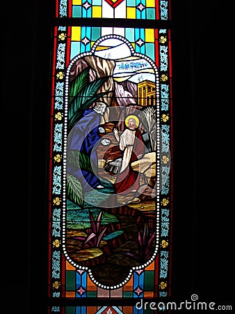 One of the artistic and colorful stained glass windows with images of the Bible in the Assumption Cathedral. Bangkok Editorial Stock Photo