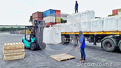 Bangkok, Thailand-16 September 2017: Workers unload jumbo bags from trailer to wooden pellet at LCB container yard Editorial Stock Photo