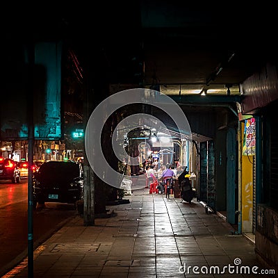 Bangkok, Thailand, Southeast Asia - People eating Thai traditional noodle soup at food stall located by the crowded road. Editorial Stock Photo