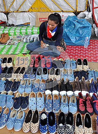 Bangkok, Thailand: Woman Selling Footwear Editorial Stock Photo