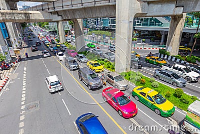 Bangkok traffic road with colorful taxi and BTS skyrail way public transport in popular travel city Editorial Stock Photo