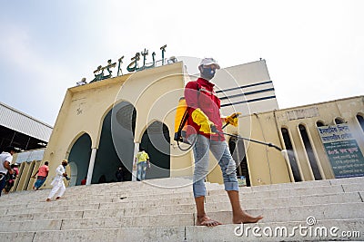 Volunteers sprayed disinfectant-mixed water at National Mosque Baitul Mukarram before the Friday Editorial Stock Photo