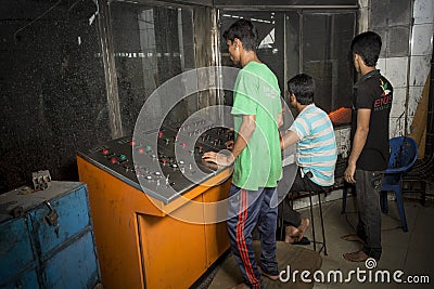 Bangladesh â€“ May 19, 2015: From metal scrap to iron rod making steel factory machine operator at Demra, Dhaka, Bangladesh Editorial Stock Photo