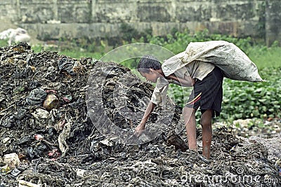 Bangladeshi boy take useful goods from landfill Editorial Stock Photo