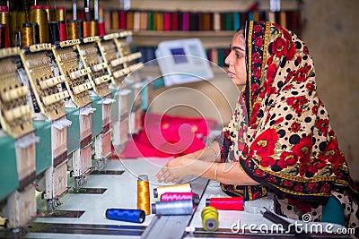 Bangladesh â€“ August 6, 2019: A Bangladeshi woman garments worker working with Computerized Embroidery Machine at Madhabdi, Editorial Stock Photo