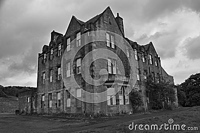 Abandoned industrial buildings from a deserted village and asylum Stock Photo