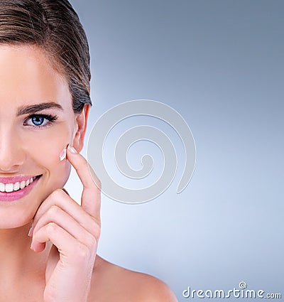 Banish bad skin days for good. a young woman applying moisturizer to her face. Stock Photo