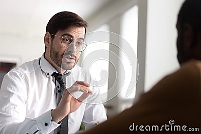 Bank advisor renders financial services to African client seated indoors Stock Photo
