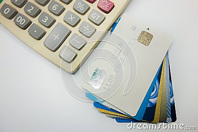 Bank cards and calculators stacked together Editorial Stock Photo