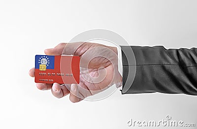 Bank credit plastic card with flag of Burma holding man in elegant suit Stock Photo