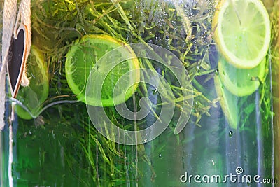 Bank with green lemonade. Tarragon Stock Photo