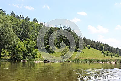 The bank of the plain river invites tired travelers to relax Stock Photo