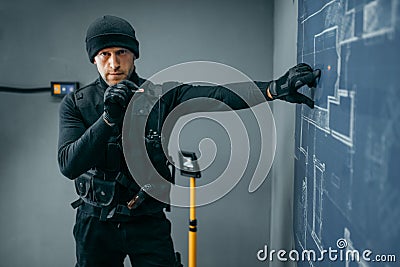 Bank robbery, male robber in black uniform Stock Photo