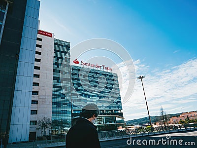 Bank worker near the headquarter of Santander Totta bank headquarter building in Editorial Stock Photo