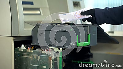 Bank worker replenishing cases of ATM with euro currency, authorized access Stock Photo