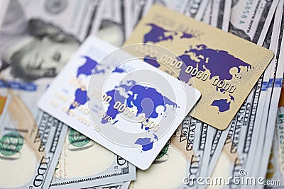 Banking cards lying on pile of US currency Stock Photo