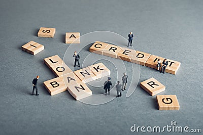 Banking concept - figurines and scrabble pieces Stock Photo