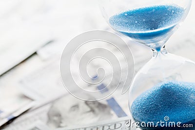 Banking, payment and debt concept. Dollar money and hourglass. Stock Photo