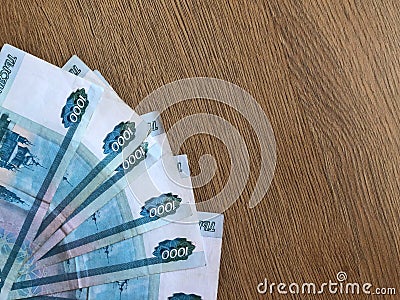 Russian banknotes in denominations of 1000 rubles on a wooden background Stock Photo