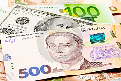 Banknotes of hryvnia, dollars, euro close-up lie on the table. B Stock Photo