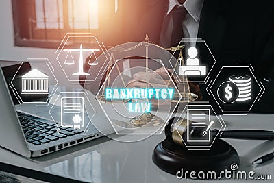 Male lawyer working on office desk with Bankruptcy law icon on virtual screen Stock Photo