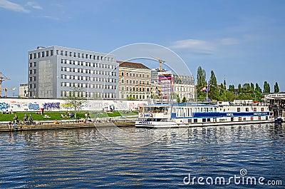 Banks of the river Spree with the East Side Gallery, Eastern Comfort Hostel Boat and Floating Lounge in Berlin Editorial Stock Photo