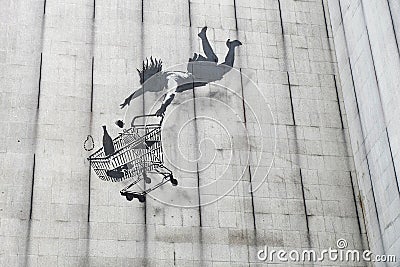 Banksy falling shopper graffiti Editorial Stock Photo