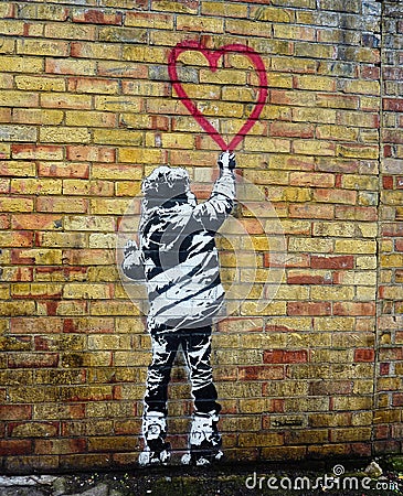 Banksy style stencil art. Child painting a heart shape Editorial Stock Photo