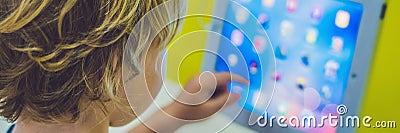 BANNER Boy playing with digital tablet. Children and technology Stock Photo