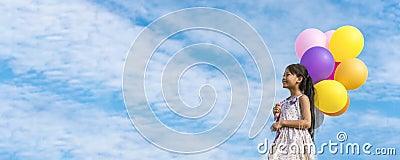 Banner Cheerful cute girl holding balloons running green meadow white cloud and blue sky with happiness. Panorama Hands holding Stock Photo