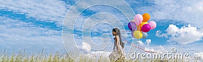 Banner Cheerful cute girl holding balloons running green meadow white cloud and blue sky with happiness. Panorama Hands holding Stock Photo