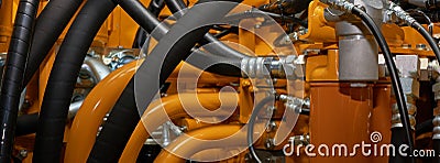 Banner with close up view of hydraulic pipes of heavy industry machine. Low key Stock Photo