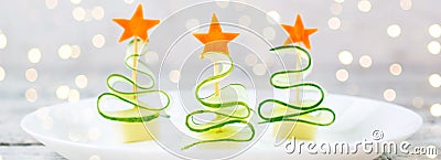 banner of Creative concept set christmas trees of cucumber, cheese and star of carrot. Funny kids food for new year Stock Photo