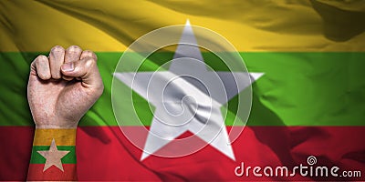 Banner of Flag of Myanmar Burma painted on male fist, fist flag, country of Myanmar, strength, power, concept of conflict Stock Photo