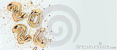 Banner with 2024 golden inflatable balloons and stars confetti. Stock Photo