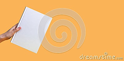 Banner with hand holding book mockup on orange background. Education, reading hobby, wisdom, intellectual development Stock Photo