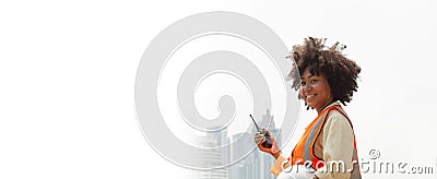 Banner image. African American female engineer, supervising outdoor work. Construction work in the city background Stock Photo
