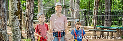 BANNER, LONG FORMAT Friends on the ropes course. Young people in safety equipment are obstacles on the road rope Stock Photo