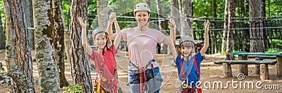 BANNER, LONG FORMAT Friends on the ropes course. Young people in safety equipment are obstacles on the road rope Stock Photo