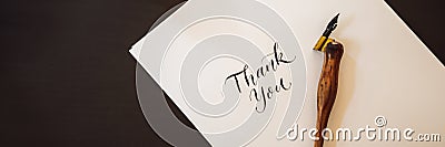BANNER, LONG FORMAT Thank you. Calligrapher Young Woman writes phrase on white paper. Inscribing ornamental decorated Stock Photo